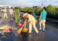 CSGT quận 12 cùng người dân thu gom cá giúp chủ xe gặp nạn