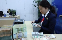 Tỉ giá VND/USD biến động không nhiều dù Mỹ vừa tăng thêm lãi suất. Ảnh: TL