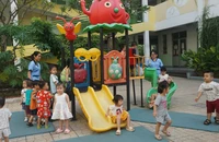 Cô và bé Trường Mầm non Mặt Trời Nhỏ đang vui chơi ngoài trời trong giờ giải lao. Ảnh: NGUYỄN QUYÊN