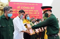 Đại diện Viện Pháp y Quân đội trao thông báo kết quả giám định ADN hài cốt liệt sĩ cho các thân nhân. Ảnh: QĐND