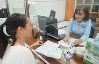 Người lao động đến cơ quan BHXH TP.HCM thực hiện một số thủ tục liên quan đến BHXH. Ảnh: NH