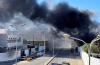 Khói đen bao trùm sau cuộc đụng độ phe phái ở thủ đô Tripoli (Libya) ngày 27-8. Ảnh: REUTERS