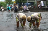 CSGT lội nước giúp người dân khơi miệng cống chống ngập