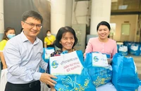 Trưởng ban Dân vận Thành ủy TP.HCM Nguyễn Mạnh Cường (bìa trái) trao quà cho các hội viên phụ nữ khó khăn tại chương trình “Xuân yêu thương - Tết nghĩa tình” do Hội Liên hiệp Phụ nữ TP tổ chức vào ngày 26-1.
