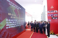 Thường trực Ban Bí thư Trần Cẩm Tú, Trưởng ban Tuyên giáo và Dân vận Trung ương Trịnh Văn Quyết cùng các đại biểu tham quan triển lãm trong khuôn khổ Đại hội XIV của Đảng tại Trung tâm Hội nghị Quốc gia. Ảnh: NHƯ Ý