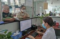 Người dân đến đăng ký khám, chữa bệnh BHYT tại Bệnh viện Gò Vấp. Ảnh: NGUYỄN HIỀN
