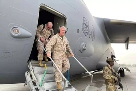 Tướng Frank McKenzie (người đeo bộ đàm) tới sân bay Kabul hôm 17-8, chỉ đạo chiến dịch rút quân và di tản khỏi Afghanistan. Ảnh: REUTERS