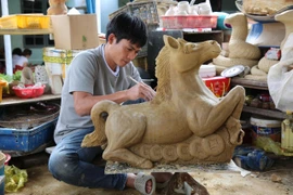 Nghệ nhân làm linh vật ngựa bằng gốm.