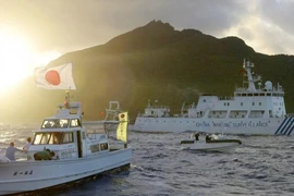 Một tàu giám sát của Trung Quốc (phải) đi qua quần đảo Senkaku, hiện do Nhật Bản kiểm soát nhưng Trung Quốc cũng tuyên bố chủ quyền và gọi là Điếu Ngư. Ảnh: KYODO