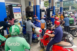 Người dân chờ đổ xăng tại một cửa hàng xăng dầu ở quận 3, TP.HCM vào trưa 11-10. Ảnh: HOÀNG GIANG