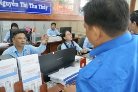 Cán bộ phường Bình Hưng Hòa, TP.HCM hướng dẫn người dân khi đến làm thủ tục hành chính. Ảnh: BẢO PHƯƠNG