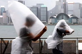 Người dân Hong Kong (TQ) đi trong mưa và gió mạnh hôm 1-9. Ảnh: SCMP