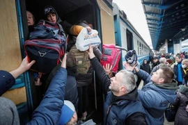 Người dân Ukraine lên tàu di cư sang các nước láng giềng. Ảnh: REUTERS
