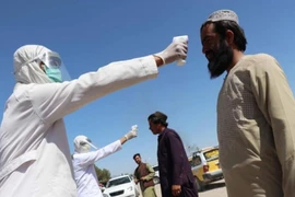 Nhân viên y tế đo thân nhiệt người dân tại Afghanistan. Ảnh: EPA