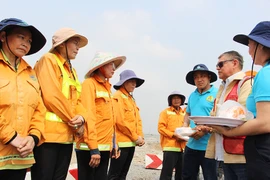 Nữ công nhân môi trường hạnh phúc với bánh kem và lì xì dịp 8-3