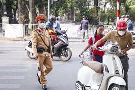 Nhiều phụ huynh ở Hà Nội 'quên' đội mũ bảo hiểm khi chở con em đi học 