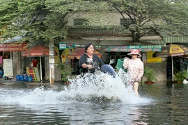 Người dân quận 12 khổ sở vượt 'biển nước' đi làm