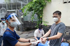 Người dân phường 11 quận Phú Nhuận nhận hỗ trợ đợt 3. Ảnh: NGUYỄN HIỀN