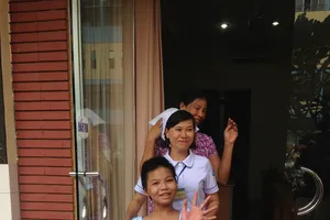 Bé gái bị mẹ tưới xăng đốt cười tươi khi xuất viện