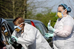 Nữ Y tá Mandy Stuckey đang lấy mẫu xét nghiệm COVID-19 tại một điểm xét nghiệm nhanh ở thành phố North Little Rock, bang Arkansas, Mỹ. Ảnh: AFP