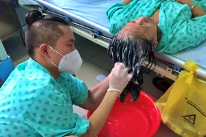 Anh Hà Ngọc Trường thường gội đầu, đút cháo… cho bệnh nhân COVID-19 ở bệnh viện.