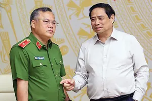Thủ tướng Phạm Minh Chính trao đổi với Thứ trưởng Bộ Công an Nguyễn Văn Long tại hội nghị. 