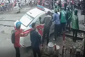 Xe taxi kẹt ở đường ray khi tàu hỏa đang tới