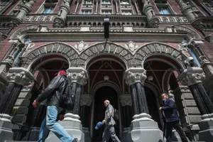 Người dân đi bộ ngang qua Ngân hàng Trung ương Ukraine hồi tháng 5-2021. Ảnh: KYIV POST