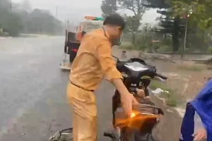 Cô gái trẻ bị cuốn váy chống nắng vào xe máy