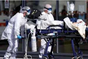 Nhân viên y tế di chuyển một bệnh nhân nhiễm COVID-19 ở TP Strasbourg, Pháp ngày 16-3. Ảnh: REUTERS