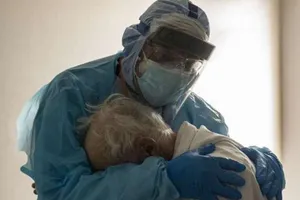 Rưng nước mắt với bức ảnh bác sĩ vỗ về cụ ông nhiễm COVID-19 