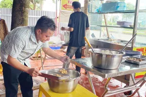 Đại úy Lê Hùng Dương tất bật chuẩn bị món ăn. Ảnh: Q.NAM 