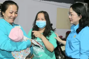 Bà Nguyễn Kim Loan, Chủ tịch LĐLĐ tỉnh Bình Dương, thăm hỏi và tặng quà cho công nhân gặp khó khăn. Ảnh: LÊ ÁNH