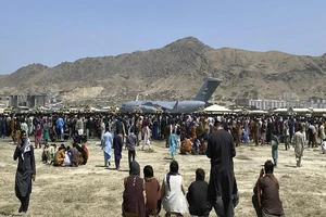 Hàng ngàn người vây quanh vận tải cơ C-7 của Mỹ tại sân bay Kabul (Afghanistan). Ảnh: REUTERS