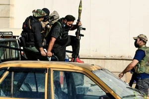 Những người biểu tình ủng hộ ông Moqtada al-Sadr xung đột với lực lượng an ninh Iraq gần Vùng Xanh, thủ đô Baghdad (Iraq) ngày 30-8. Ảnh: REUTERS