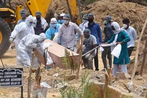 Chôn cất người chết vì COVID-19 ở New Delhi (Ấn Độ). Ảnh: CNN