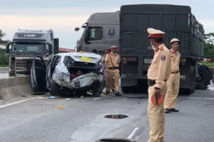 Chiếc xe ô tô con biến dạng sau va chạm với container