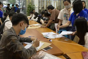 Phụ huynh, thí sinh làm thủ tục nhập học tại trường ĐH Công nghiệp TPHCM. Ảnh: TRUNG NHÂN