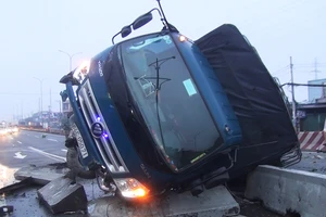 Xe tải lật trên quốc lộ 1A trong mưa, tài xế, phụ xe mắc kẹt