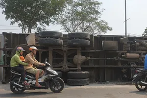 Ô tô tải chở sắn lật vào làn xe máy ở Hóc Môn