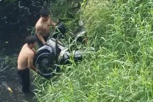 Xe máy nằm dưới kênh nước đen, người điều khiển không rõ ở đâu