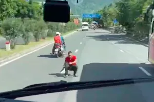 Công an mời người đàn ông ngồi chắn ô tô giữa đường lên làm việc