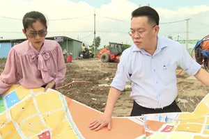 Ông Hoàng Văn Quân cùng đồng nghiệp trao đổi về dự án đường vành đai 3. Ảnh: NVCC