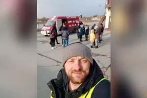 Mykhailo Puryshev chụp một bức ảnh phía trước chiếc xe van anh sử dụng để sơ tán những người dân khỏi TP Mariupol.