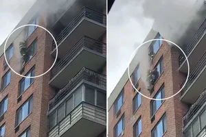 Lính cứu hỏa giải cứu phụ nữ mắc kẹt ở cửa sổ tầng 16