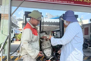 Người dân đổ xăng tại cửa hàng quận Bình Thạnh, TP.HCM. Ảnh: TÚ UYÊN