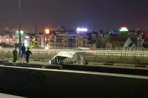 Ô tô BMW bị gỡ biển số, trùm bạt kín nằm trên cầu Sài Gòn