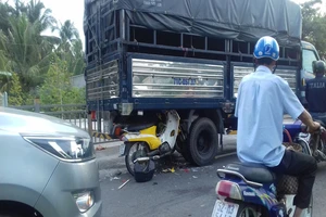 Xe máy găm vào gầm ô tô tải trên quốc lộ, 2 người trọng thương