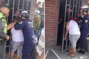 Ngó nghiêng nhà hàng xóm, phụ nữ bị mắc kẹt đầu vào song cửa