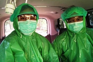 Bác sĩ ở một bệnh viện điều trị COVID-19 tại TP akasar (Indonesia) mặc áo mưa thay cho đồ bảo hộ Ảnh: IDN TIMES